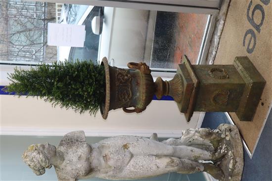 A pair of cast iron two handled campana shaped garden urns, on square plinths H.112cm